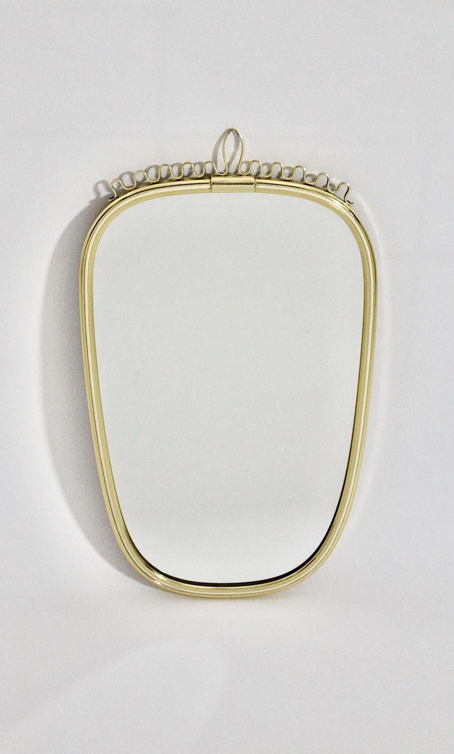 Mid-Century Modern vintage wall mirror oval like from solid brass with white inner edge and slightly curved details at the upper part 1960s Germany.
Very good condition with minor patina
labeled at the fibre board backside:
Metallrahmenspiegel