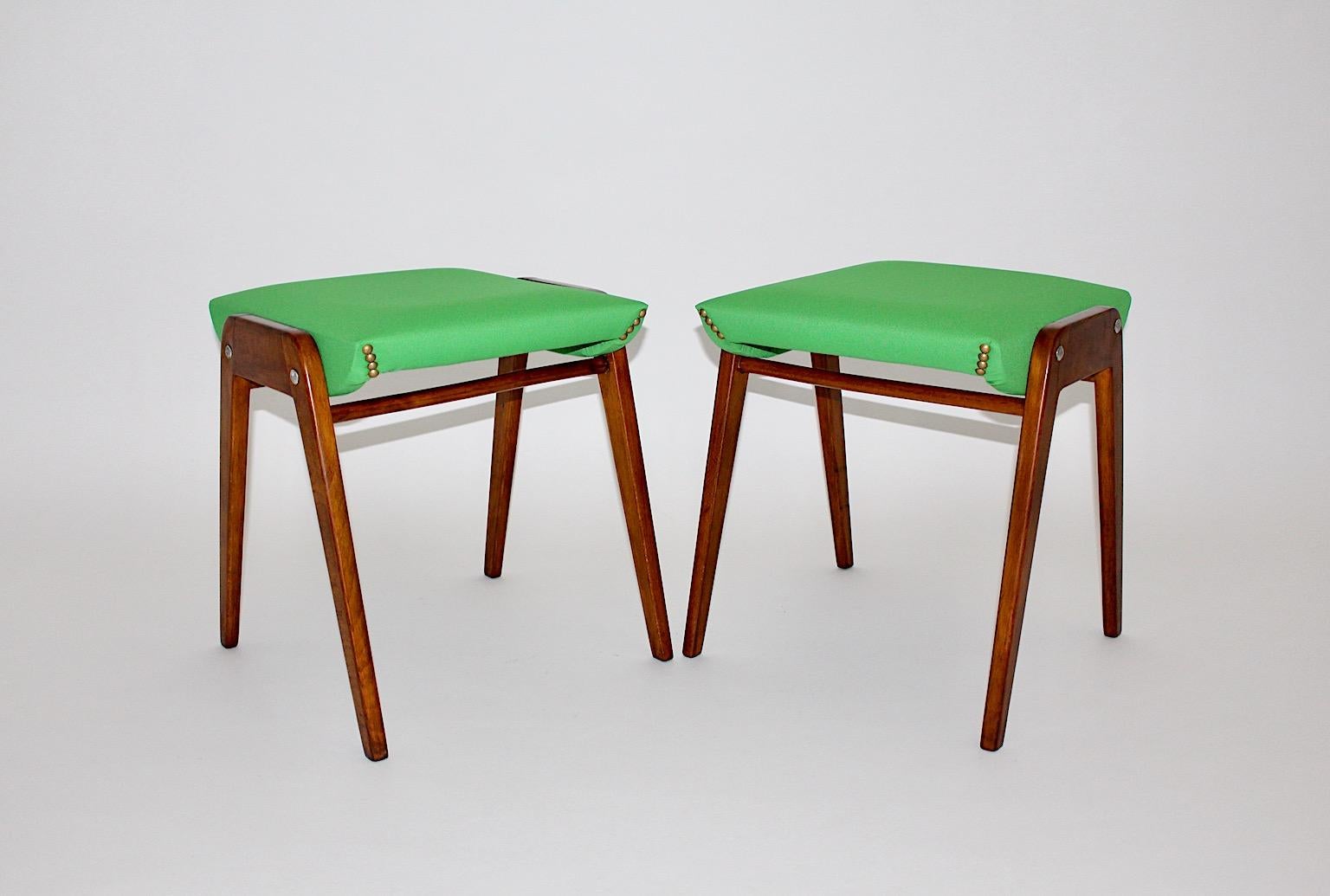 Mid Century Modern vintage pair of stools model SW 2 from beech by Roland Rainer circa 1955 Austria.
While the seat is reupholstered with light green fabric, the frame from beech is shellac polished by hand.
Bold fresh color combines with warm