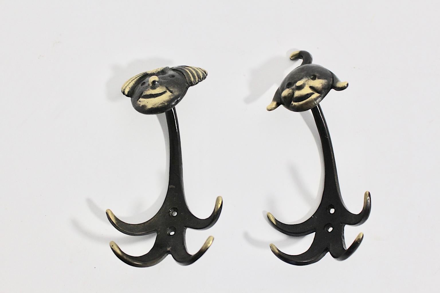 This rare Mid-Century Modern vintage pair of brass wall hooks 