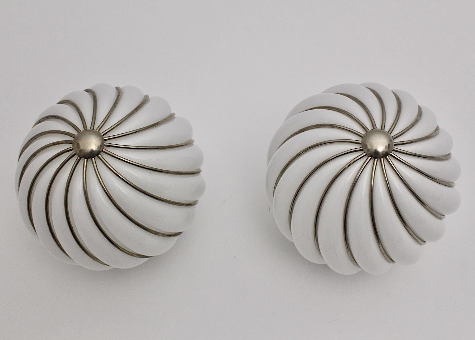 Mid-Century Modern pair of vintage flush mounts by Adolf Loos for Veart Murano, Italy 1960s.
An amazing white handmade glass ball with slightly curved nickel-plated lines, which shows a beautiful movement in its design. A round button sits in the