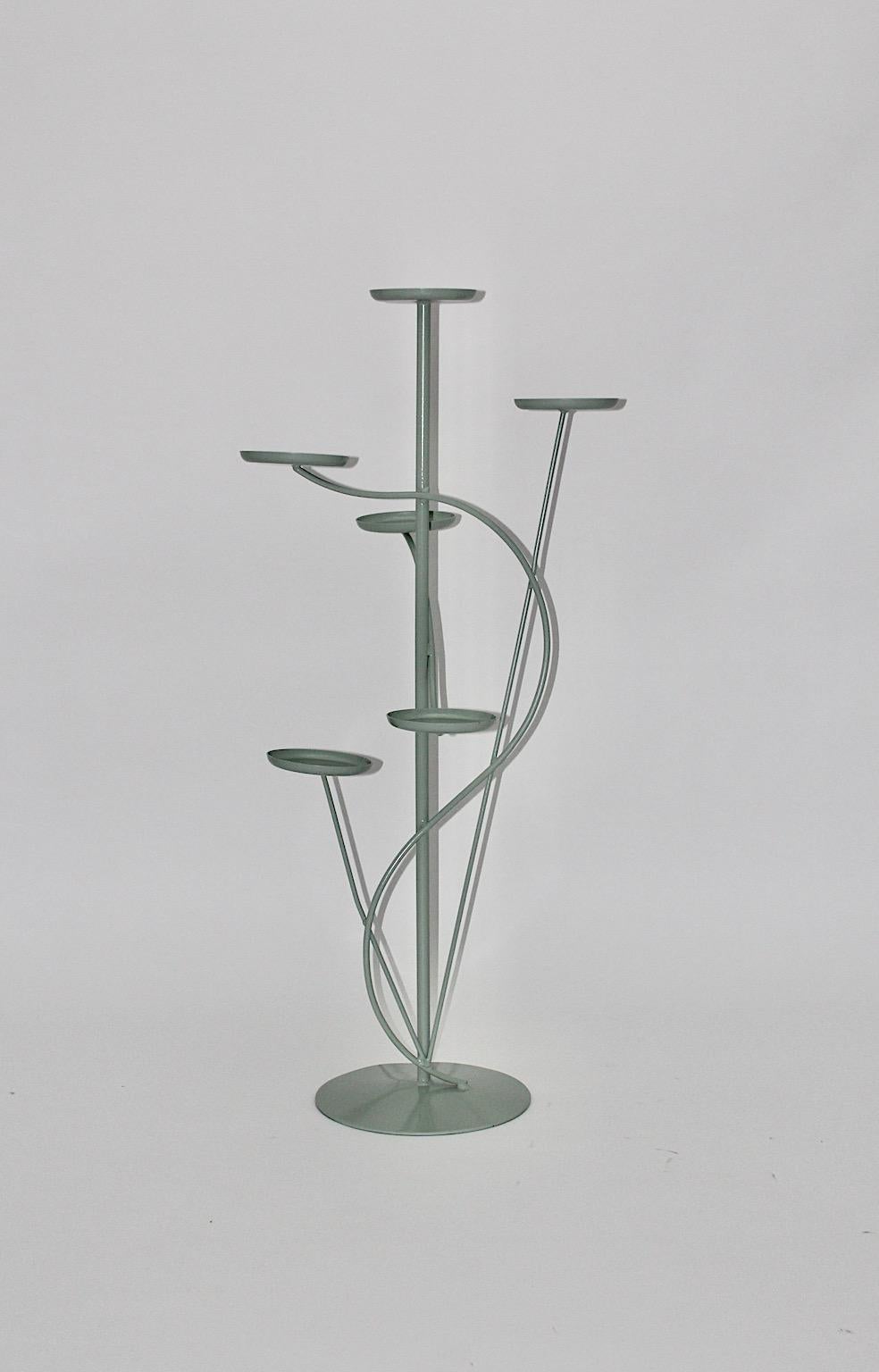 Mid-Century Modern Organic vintage flower stand from metal in soft pastel green color with 6 cups 1950s Austria.
A stunning flower stand with 6 cups in great organic shape for presenting the plant pots, new lacquered in soft green pastel color.
This