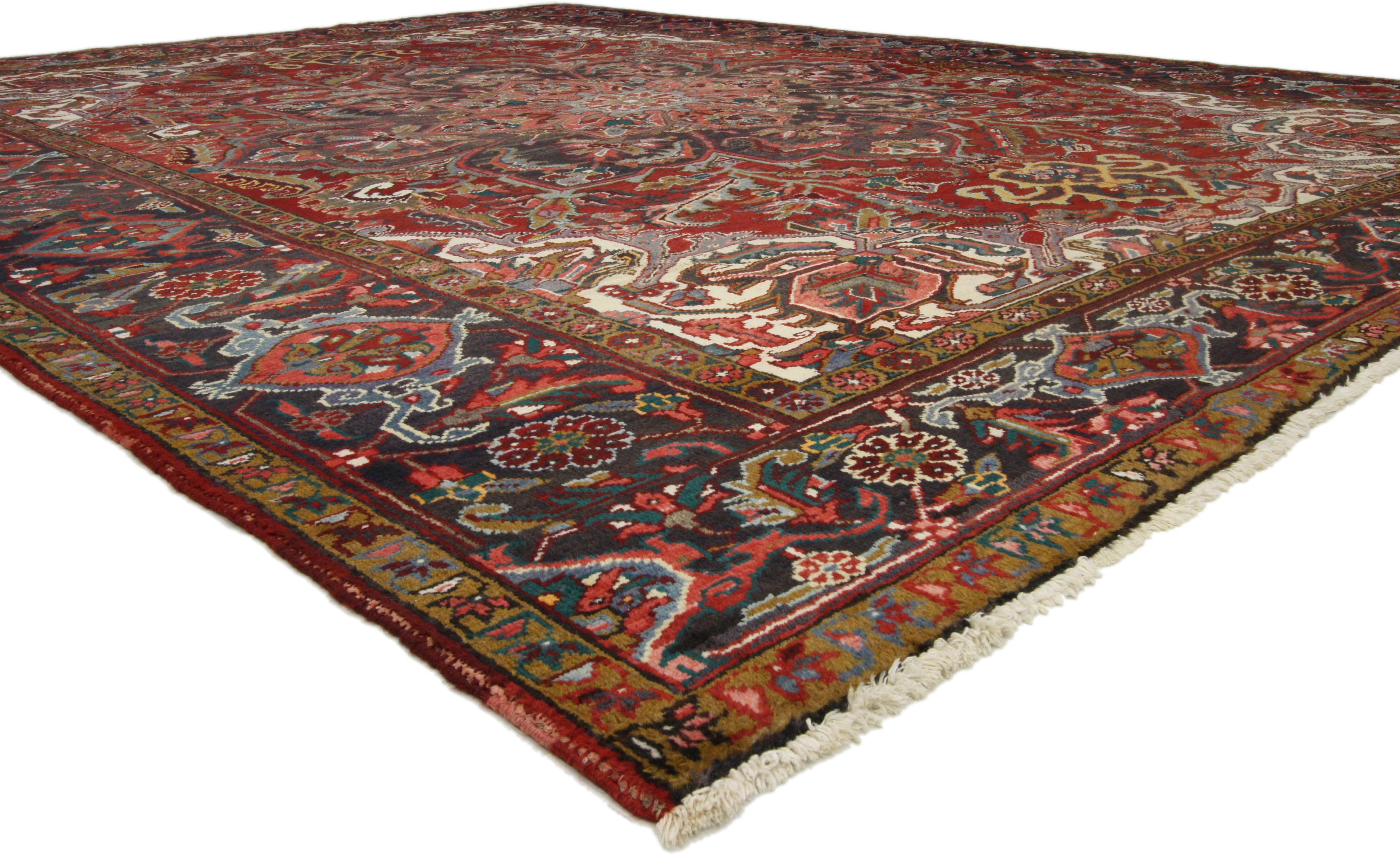 74496, Mid-Century Modern vintage Persian Heriz rug with craftsman style. This hand knotted wool vintage Persian Heriz rug features an ornate floral lobed center medallion across an abrashed scarlet red field. Large palmettes, lanceolate leaves,