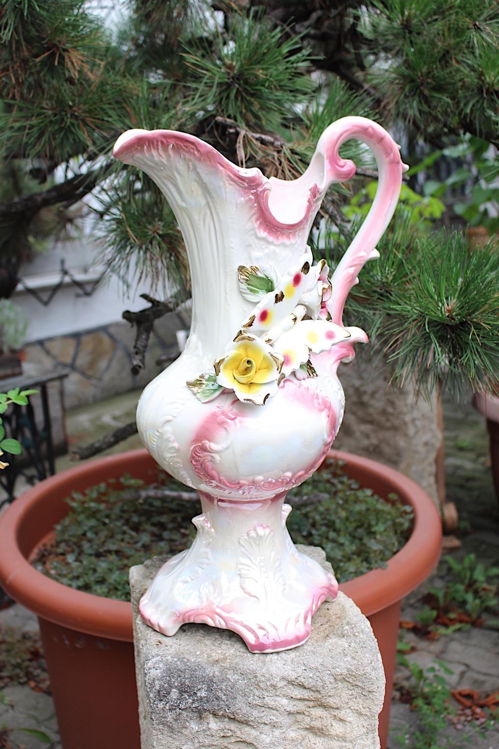 Mid Century Modern vintage pitcher from porcelain in white and pink pastel color tones by the famed Italian porcelain manufacture Capodimonte 1950s Italy.
The amazing porcelain pitcher shows decor roses and a butterfly in pastel colors.
This