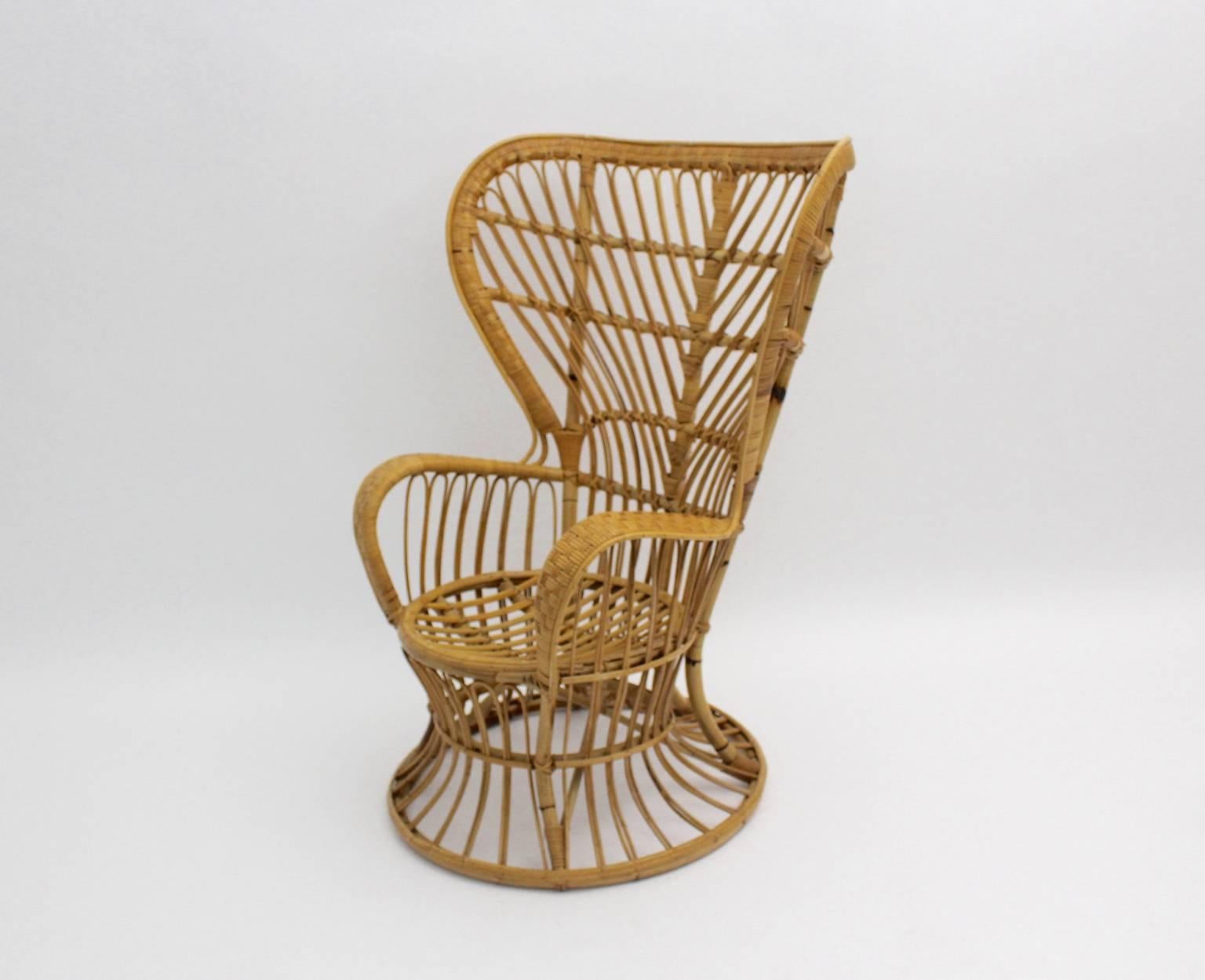 Riviera Style organic vintage lounge chairs, armchair or wingback chairs from rattan  designed by Lio Carminati, in the manner of Gio Ponti circa 1948 and manufactured in Italy, 1950s.
We offer from one up to six chairs. 
The rattan work