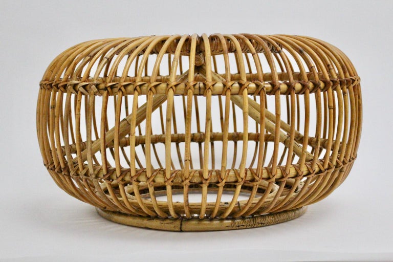 We present a very elegant woven rattan pouf or ottoman designed in the style of Franco Albini, Italy.
Many rattan rods form and set this structure.
It is smart and transparent design and nevertheless the pouf is very stable.
Very good vintage