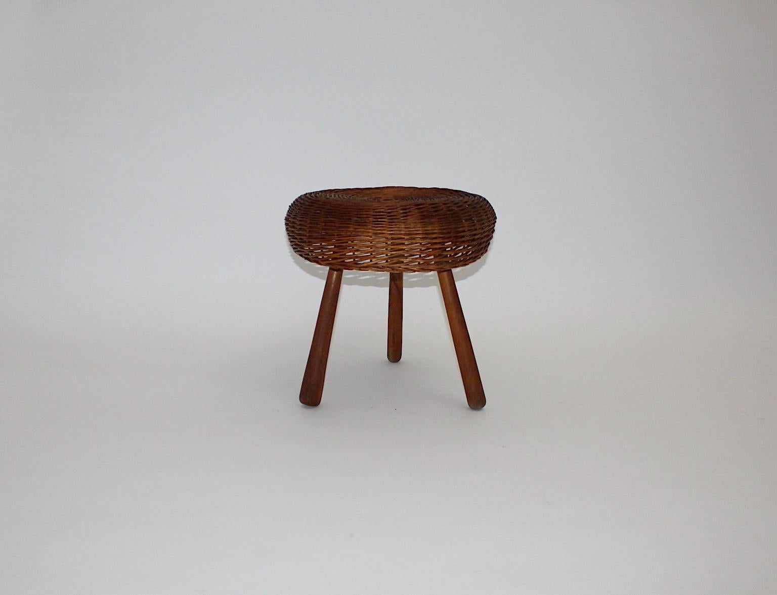 Mid-Century Modern vintage organic stool from rattan and walnut attributed Tony Paul, 1950s United States.
Stunning stool shows a network from rattan for the seat and conical shaped walnut feet.
Walnut wood features warmth and depth.
The stool is