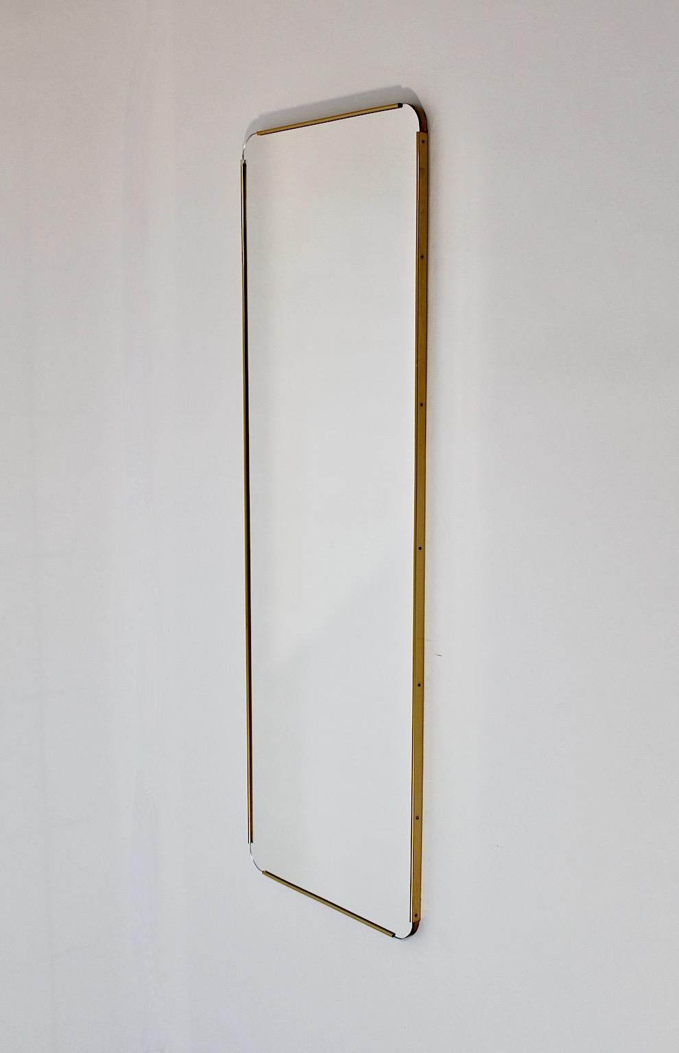 Mid Century Modern vintage floor mirror full length mirror in rectangular shape with brass frame, 1950s Italy.
An amazing vintage full length mirror or floor mirror with brass details along all sides and slightly rounded edges in rectangular