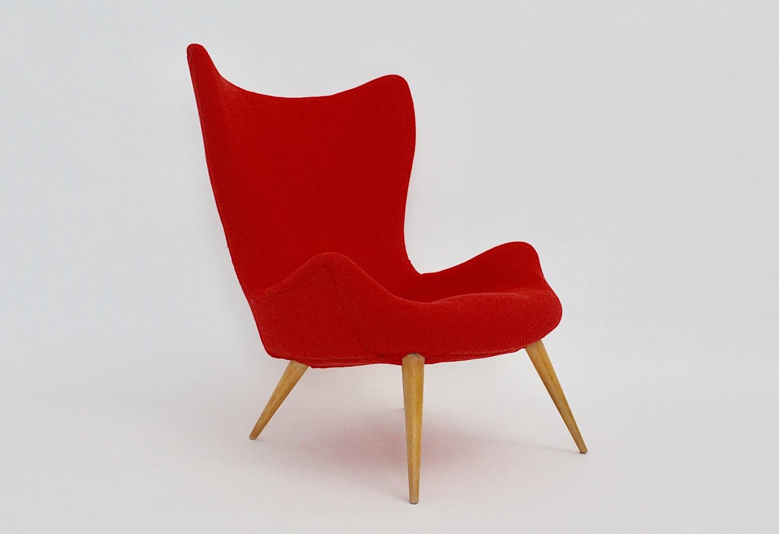 Mid Century Modern vintage lounge chair or club chair from beech and red woolen fabric 1950s.
A stunning lounge chair with four ( 4 ) beech wooden feet and a new cover from cherry red textile fabric by Kvadrat from the 1950s.
This club chair or