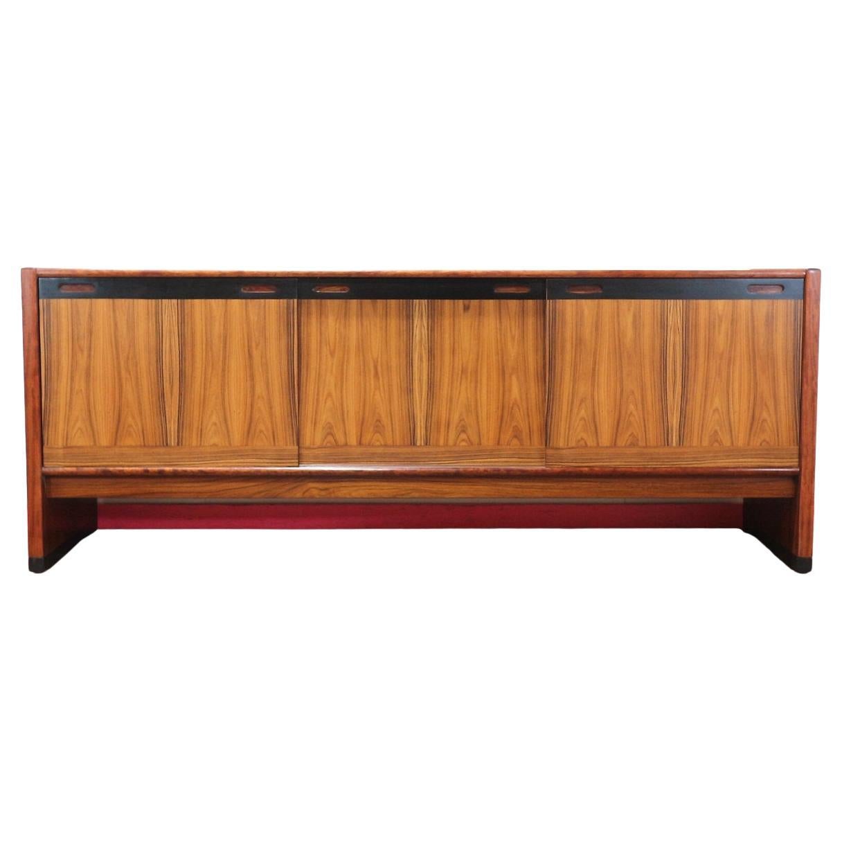Revel in the timeless elegance of the Mid Century Modern Vintage Rosewood Credenza by Skovby Danish Furniture, available exclusively at Mid Century Traders. This exquisite credenza exemplifies the finest in mid-century modern design, boasting rich