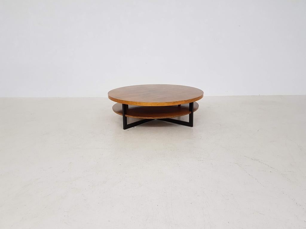 Vintage rosewood, teak and metal round coffee table, 1960s

Very beautiful round table with a high quality lacquered rosewood veneer top. The second lower tabletop is made of wood with teak veneer. The tops are resting on a black metal