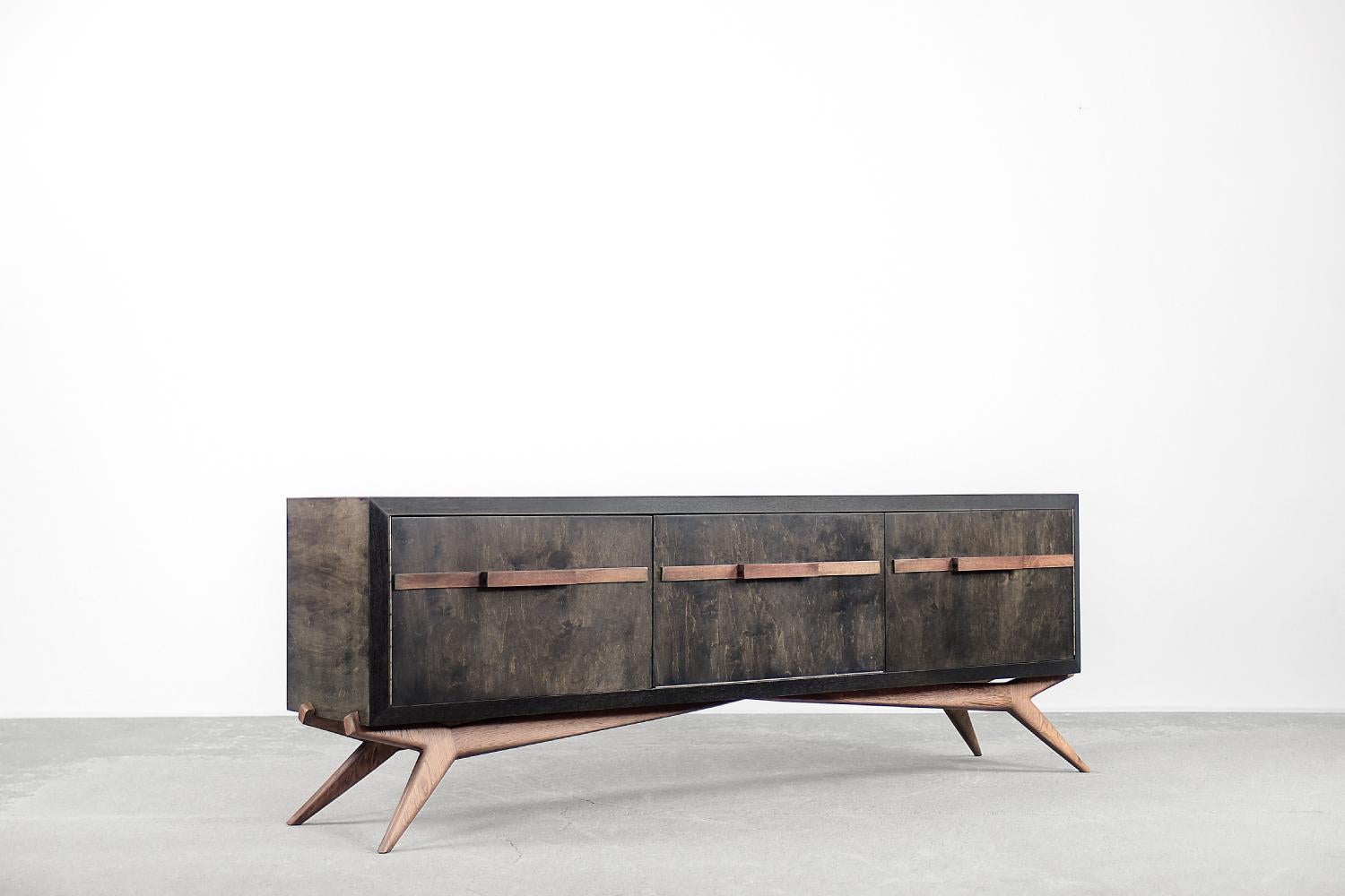 This rare sideboard was made in Scandinavia during the 1960s. It is finished with birch wood with a strong and irregular grain and a characteristic earthy color, where browns and grays merge in contrasts of varying intensity. This sideboard has two