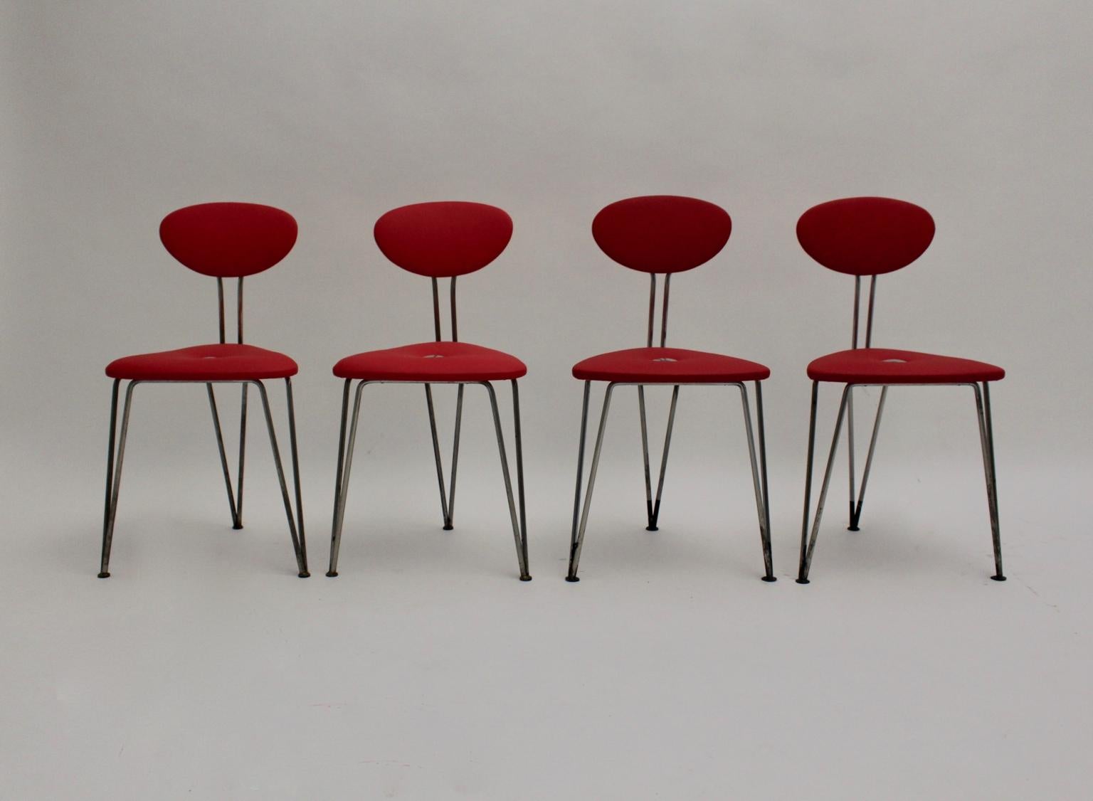 Mid Century Modern set of four chairs designed and made in Vienna circa 1950 by Günter Talos. The chairs are stamped.
The triangle shaped seat and the oval shaped back are newly covered with cherry red faux leather and fixed with decorating