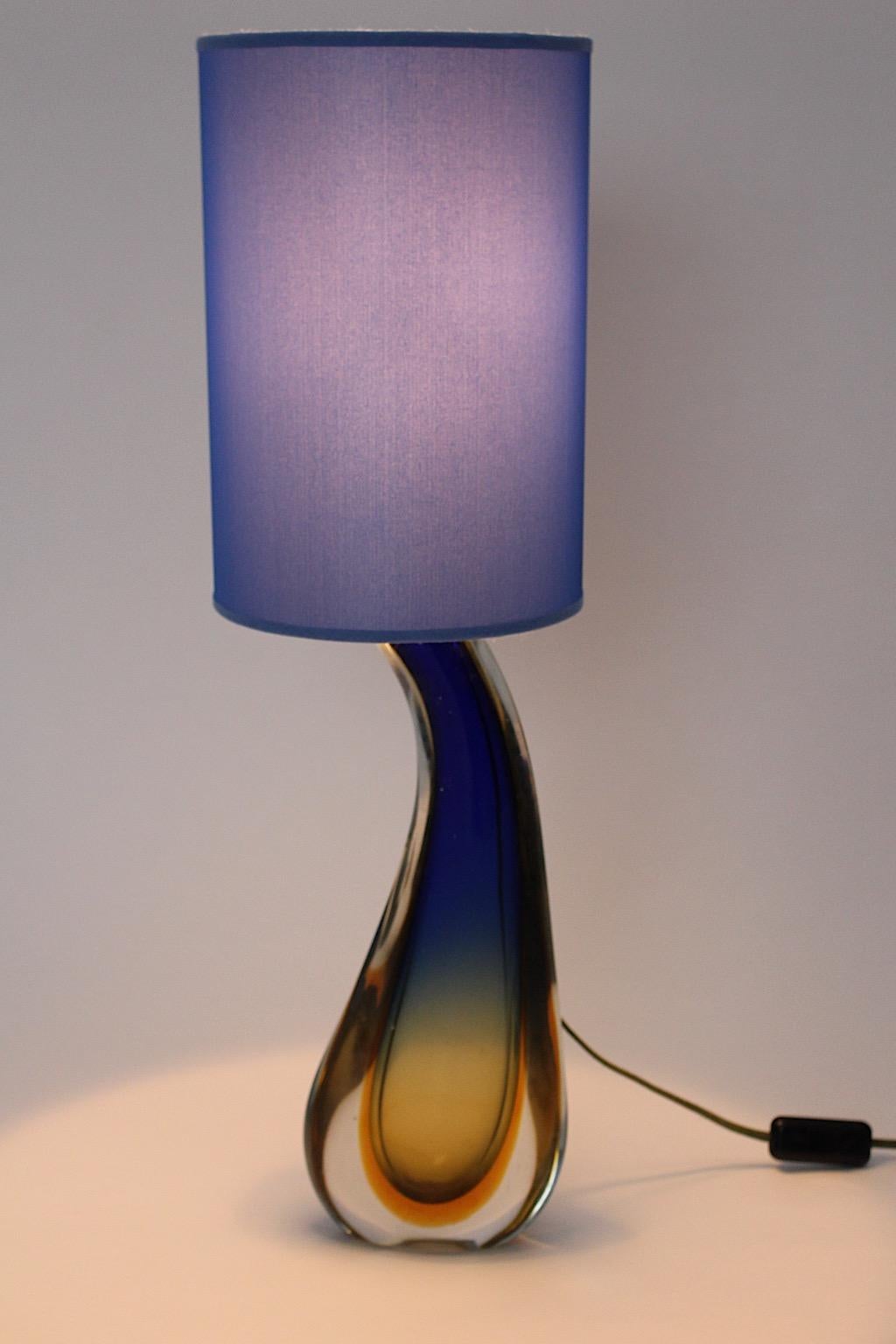 Mid Century Modern vintage table lamp from Murano blown glass in pastel blue and soft orange color by Flavio Poli 1950s Italy. 
A charming and dreamy table lamp in pastel blue and soft orange colors from blown glass Italy 1950s.
This table lamp