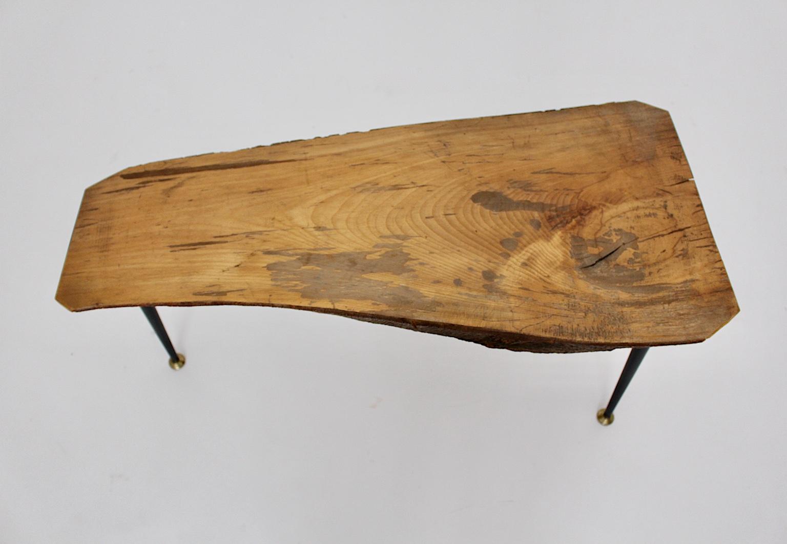 Mid Century Modern Vintage tree trunk coffee table, Austria 1950s.
A solid Vintage cherry wood tree trunk table, which shows three black lacquered metal feet with brass sabots.
The table was made in Austria in the 1950s.
The vintage condition is