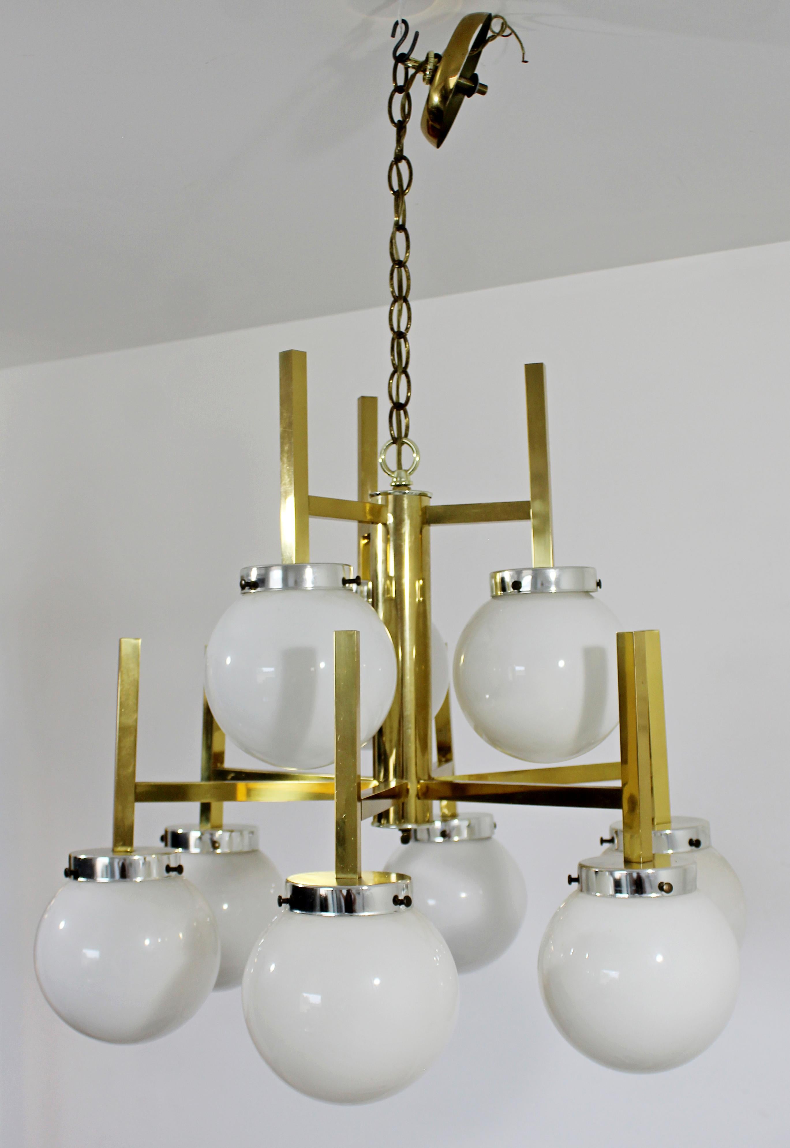 For your consideration is a brilliant, brass light fixture chandelier, with nine white glass bulbs, by Robert Sonneman, circa 1960s. In very good vintage condition. The dimensions are 24