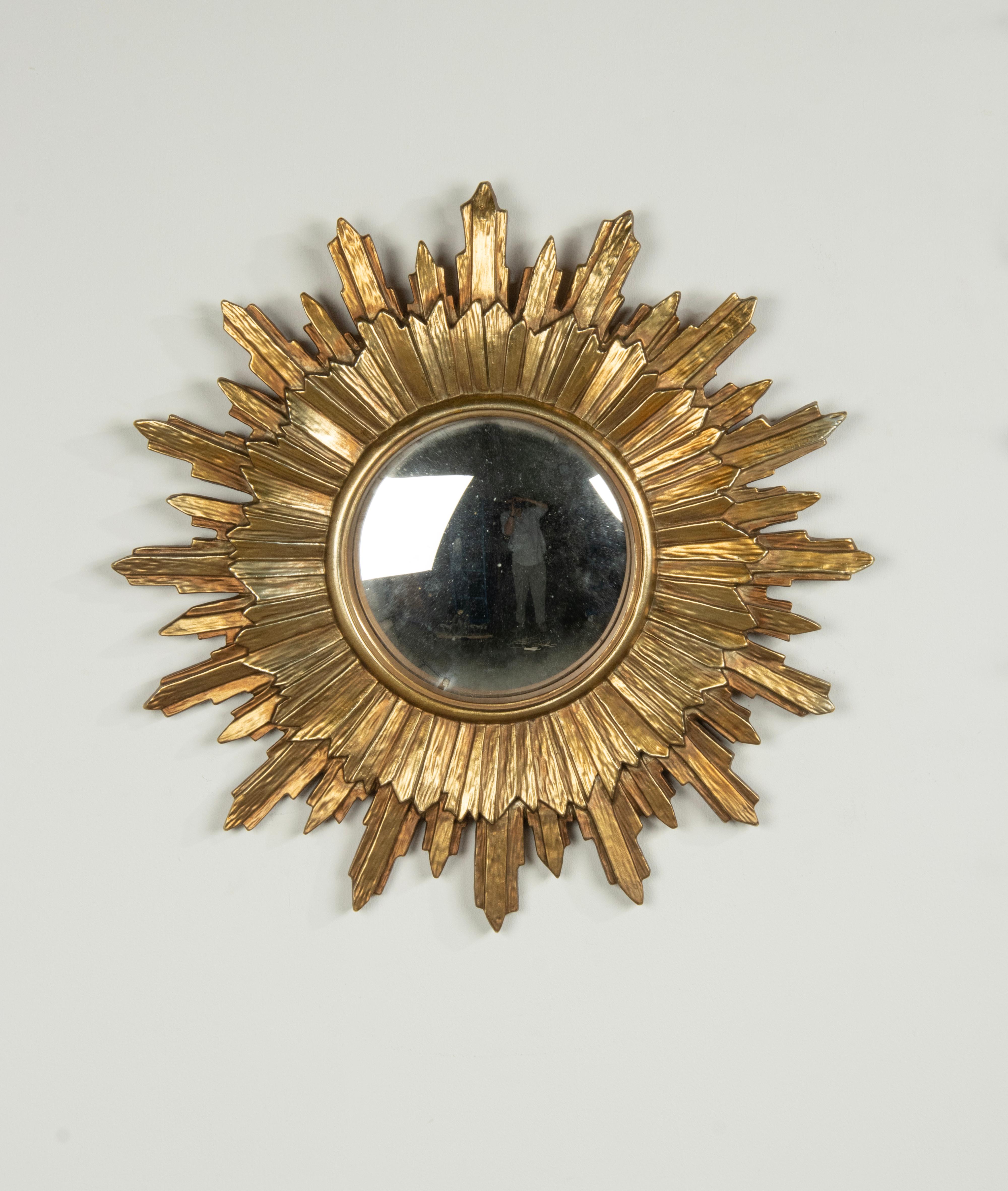 A beautiful mid century modern sunburst mirror. Made of epoxy resin, beautifully gold patinated. 
The mirror is Ø59 cm, the mirror glass is Ø20 cm. 
The mirror is in good condition. 
Free shipping.