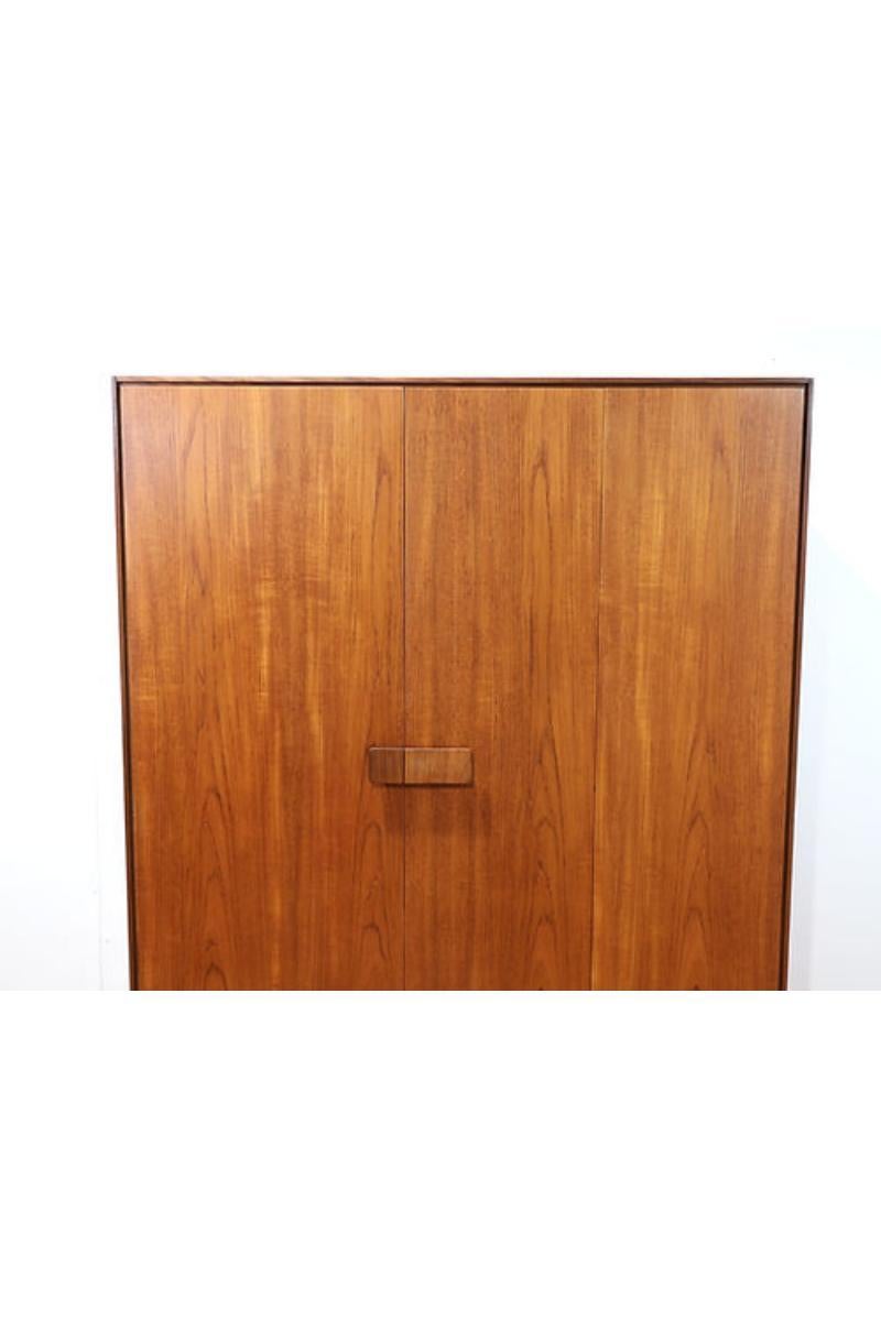 This stunning wardrobe by G plan is part of their Danish range and designed by renowned designer, Kofod Larsen. Made from teak and teak veneer it has ample storage space whilst looking super stylish with its sculpted handles,