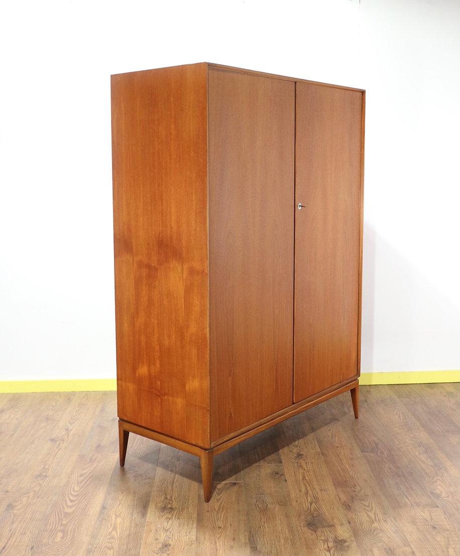 This lovely simple wardrobe is very typical of its era in design and sure to look just as beautiful in the home today as when it was first purchased.

With ample storage space including a hanging rail, this handsome wardrobe will neatly store and