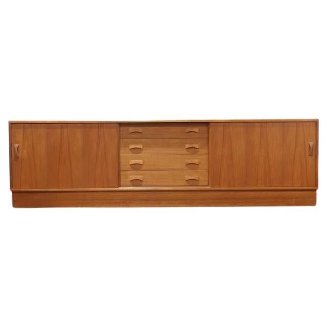 Stylish sideboard in teak with generous storage space. Made by Clausen & Son.

This lovely sideboard provides a generous amount of storage with space behind its two sliding doors.
Each has a single internal shelf which are adjustable or can be