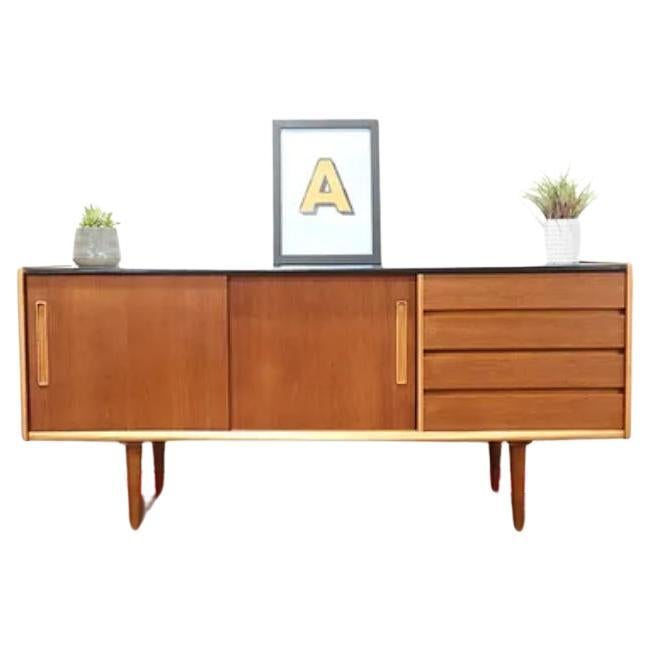 A Jentique Mid-Century Teak Sideboard, Danish styled, British made.

The compact design is great for the modern home and offers lots of storage.

Provides great style, storage and display options for a kitchen or living area.

A large double