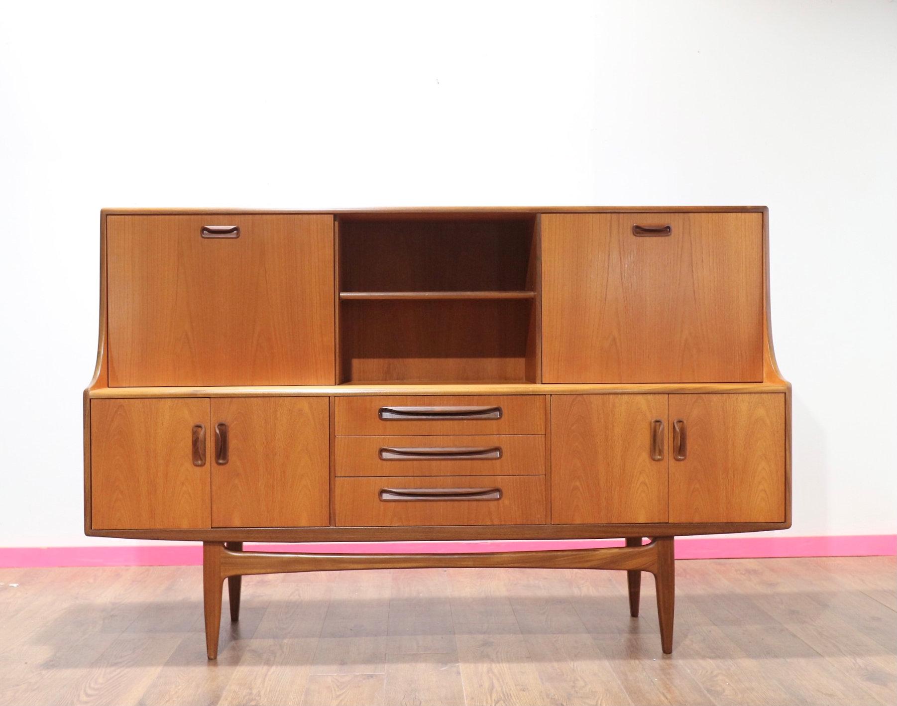 This delightful high credenz was designed by Victor Wilkins for G Plan in the mid-twentieth century.G Plan is renowned for their iconically designed well-manufactured British furniture throughout the mid-twentieth century.The piece features two