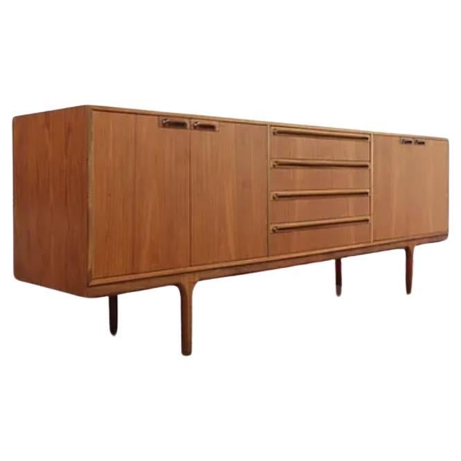 Vintage mid century teak sideboard manufactured during the 1960s by A.H. McIntosh in Kirkcaldy Scotland and was designed by Tom Robertson. The drinks cabinet has a pull out shelf for preparing drinks.
