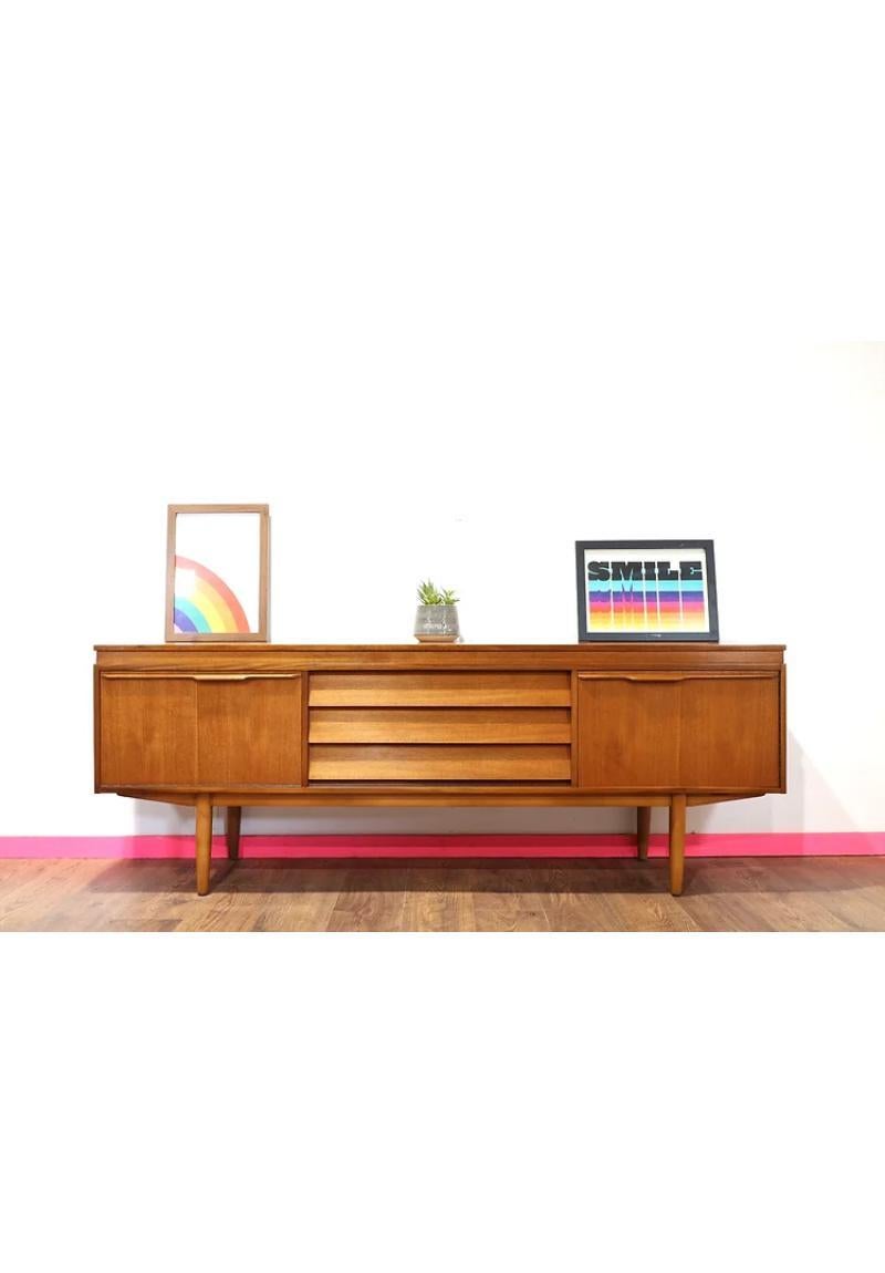 This fabulous credenza and designed Morris of Glasgow s in the 60s. This is a classic british credenza with danish style and great storage is a beautiful piece of furnitrue that would look stunning in any enviroment.