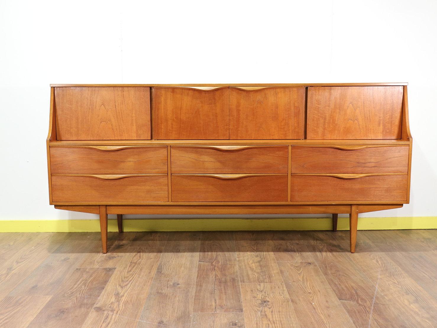 A fabulous credenza made by British furniture maker Sutcliffe of Todmorden in the 1960s. Stunning sculpted handles and a beautiful grain plus plenty of storage ake this cabinet a must.

 

Dimensions 

w72 d18.5 h34.5

 

Condition

