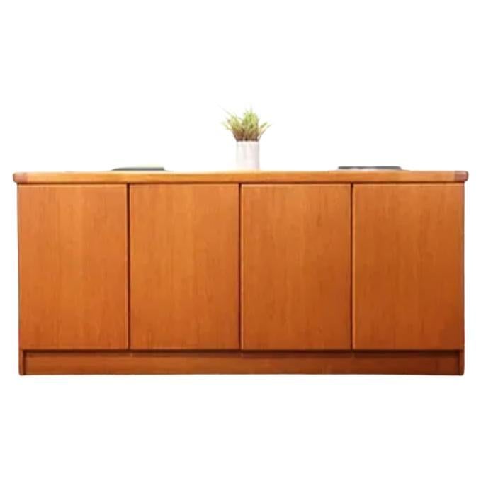 This gorgeous vintage teak Danish credenza sideboard by Cristian Linneberg is a stunning addition to any mid century modern home. With its sleek, minimalist design and warm teak wood finish, this piece matches seamlessly with a variety of interior