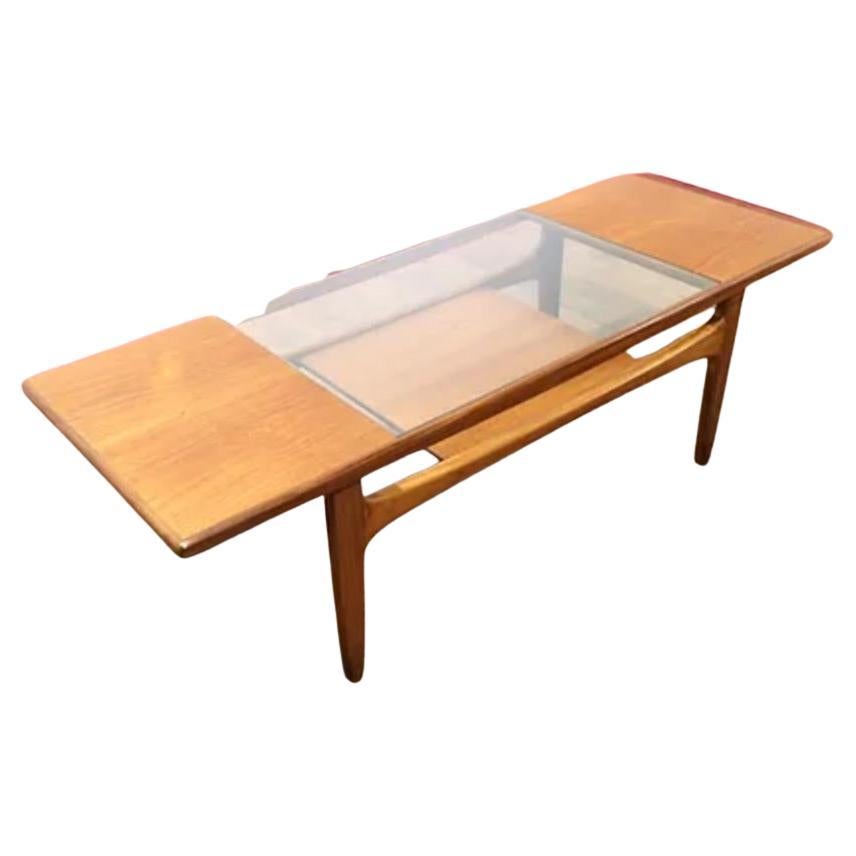 Introducing the Mid Century Modern Vintage Teak Danish Style G Plan Coffee Table, a stunning piece of furniture from the renowned British furniture maker G Plan. Crafted from high-quality teak, this coffee table features a beautiful grain that adds