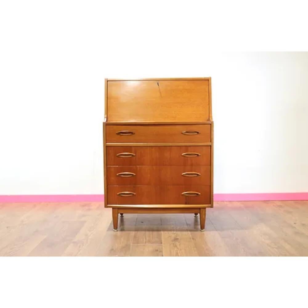  

The Mid Century Modern Vintage Teak Desk Secretaire by Jentique is a stunning addition to any mid century furniture collection. Made by the renowned British furniture maker Jentique, this desk features the clean lines and elegant design of mid