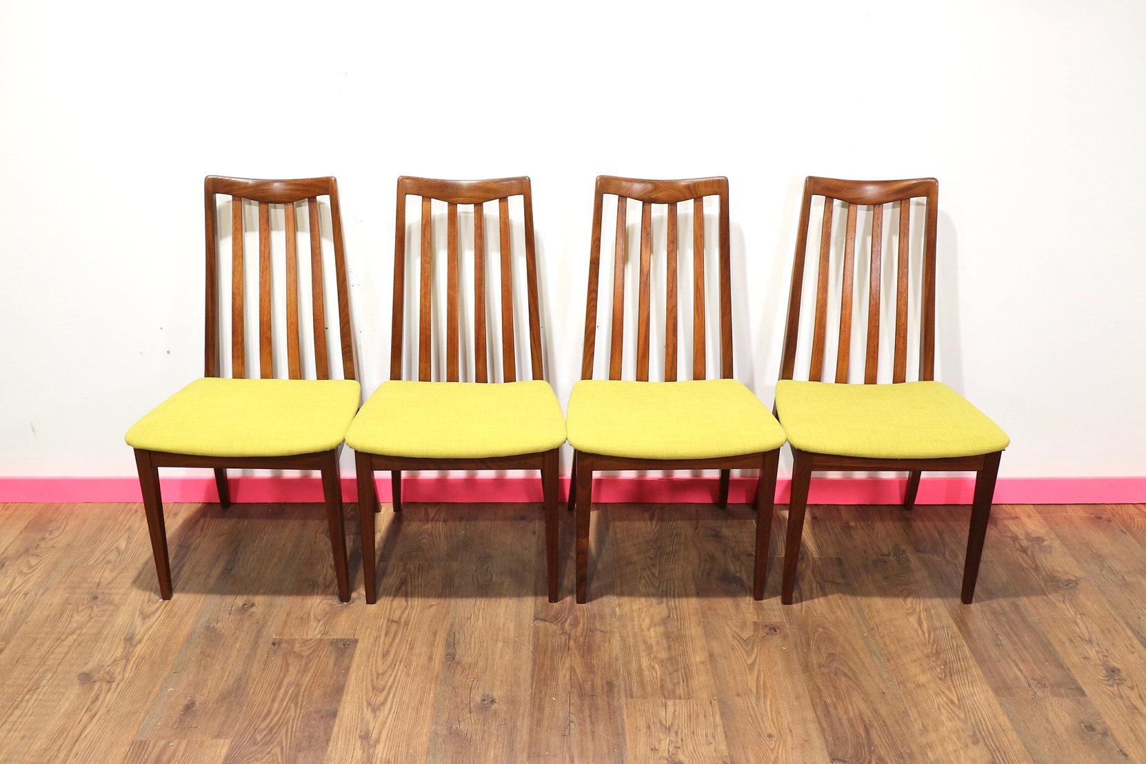 A gorgeous set of 4 G Plan teak framed dining chairs from their Brasillia range. These fabulous chairs have had the seat pads recently upholstored in teal to give them a really striking look. They would look great in any dining room.

