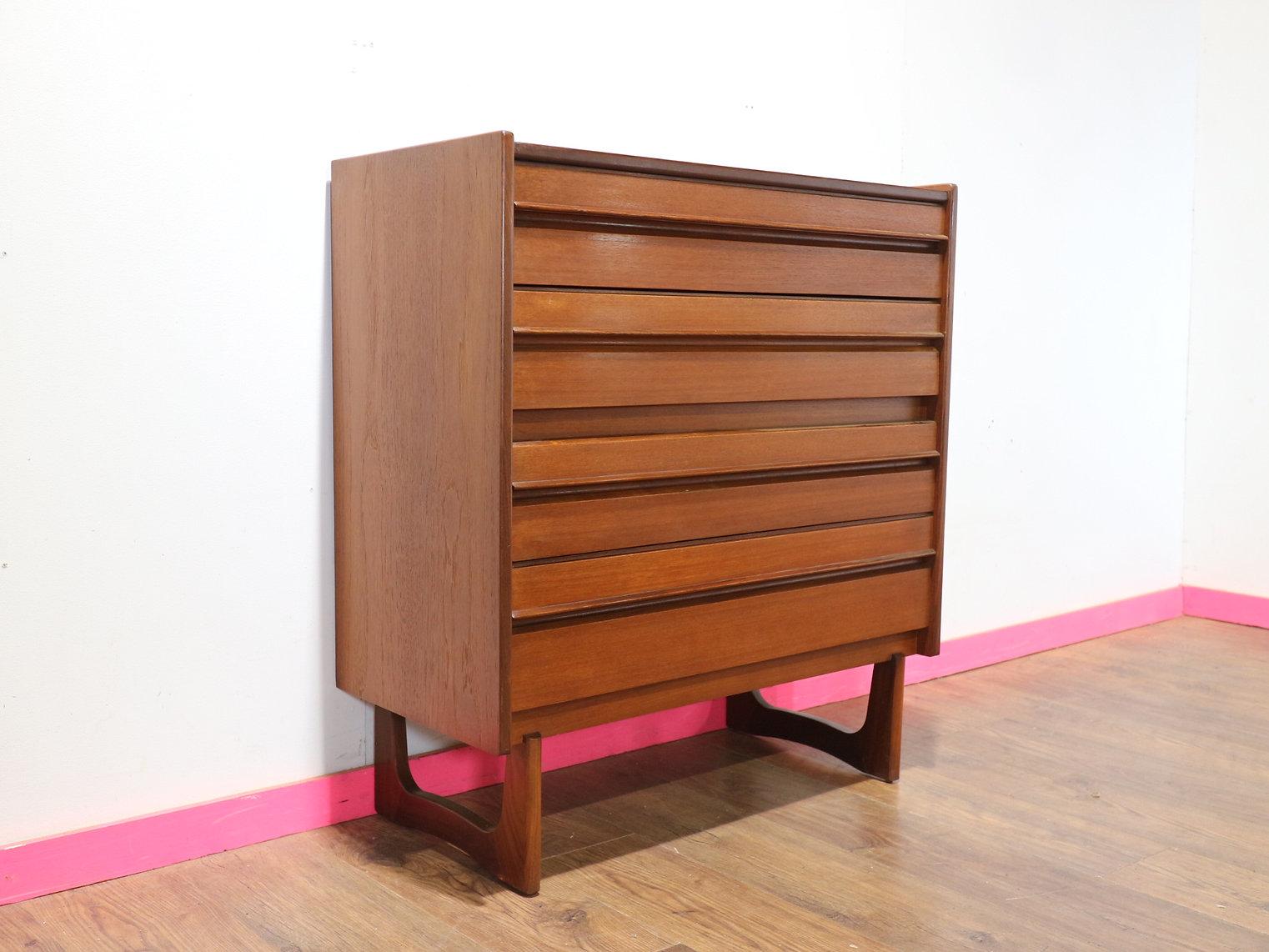 Discover the epitome of sophistication with the Mid Century Modern Vintage Teak Dresser by William Lawrence. This stunning dresser, adorned with gorgeous curved legs, embodies Scandinavian design and timeless elegance, making it a perfect addition