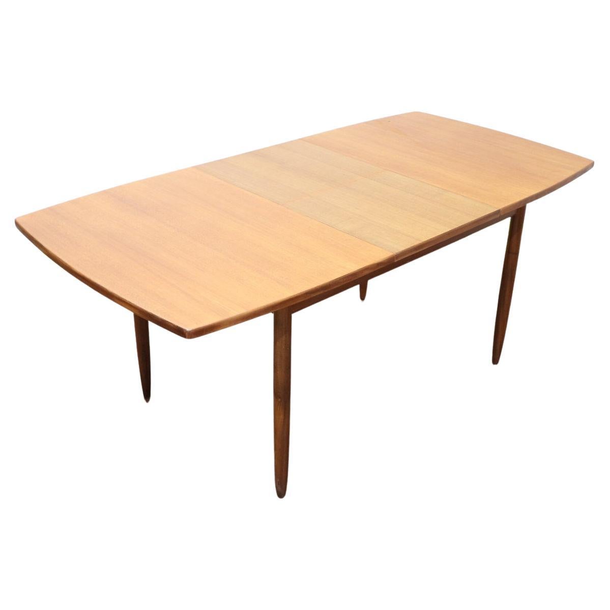 A beautiful teak extending dining table by British furniture maker, William Lawrence. This table has beautiful golden grain and can sit 4 people or 6 comfortably when extended. The extension piece is in built and just folds out 

 

Dimensions