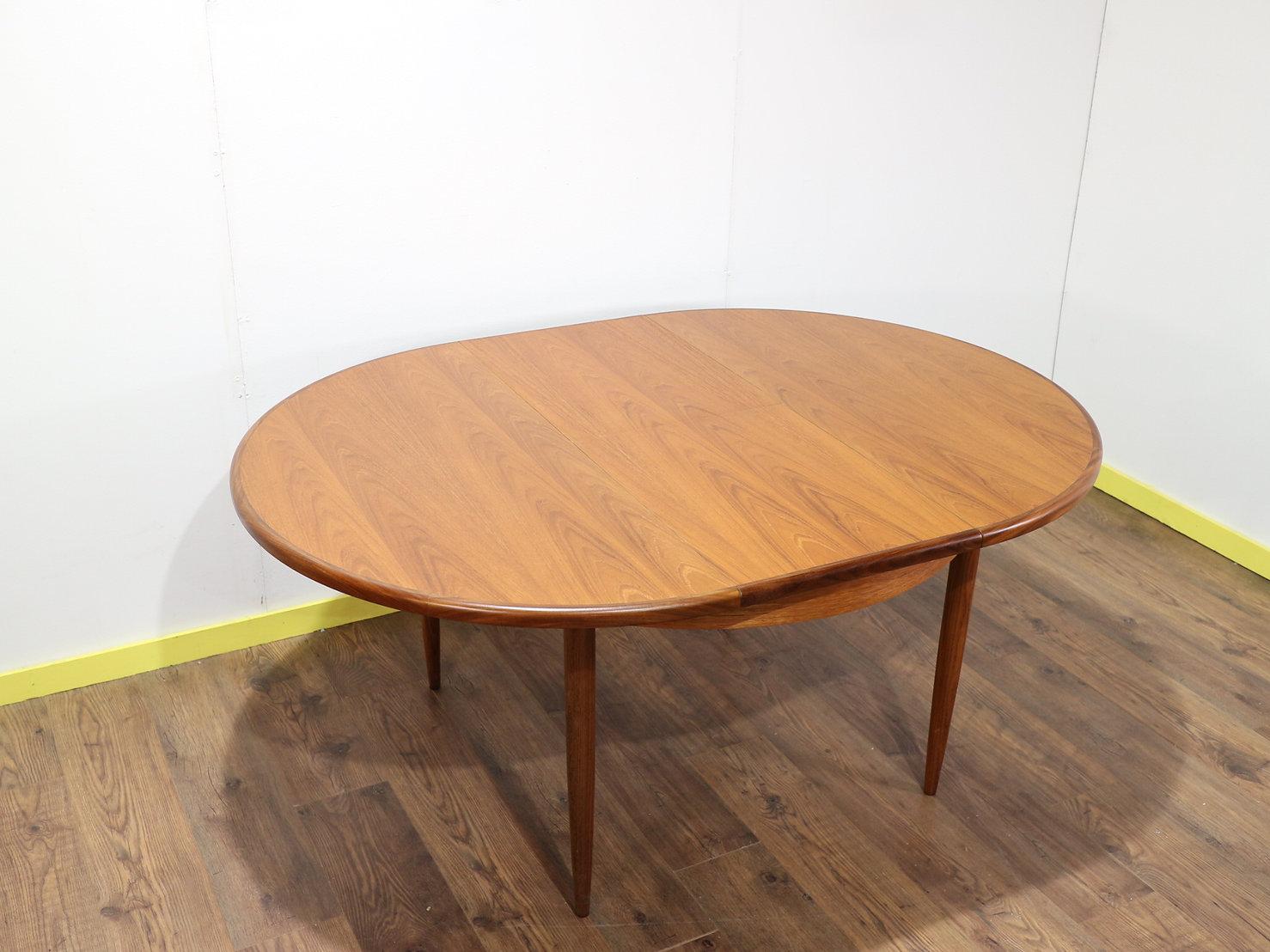 A stunning and iconic vintage teak dining table. part of the Fresco range made in England by G Plan.

This fantastic table has a wonderful grain and has a fold out built in extension so the table can go from seating 4 to seating 6 comfortably.

