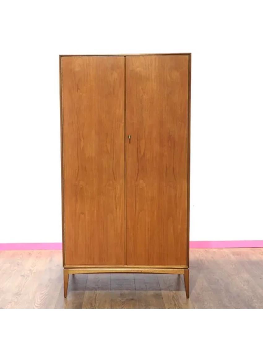 This lovely simple stylistic gentlemens wardrobe is very typical of its era in design and sure to look just as beautiful in the home today as when it was first purchased.

With ample storage space including a hanging rail and shelving.

Along with G