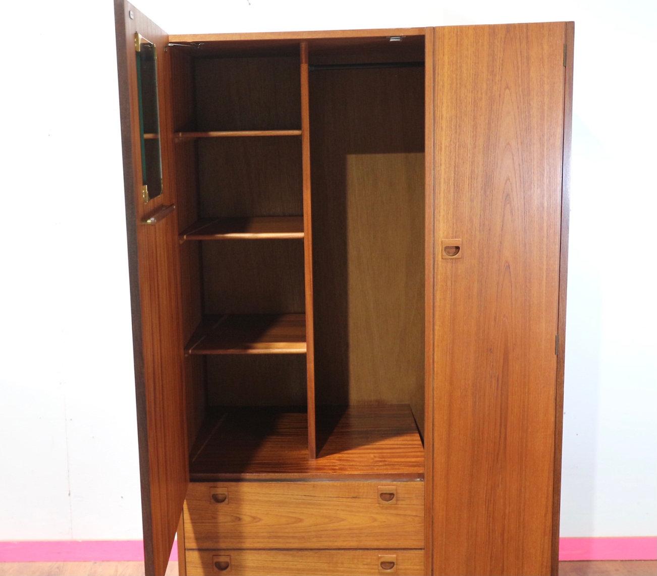 Elevate your space with a mid century modern teak gentlemens armoire wardrobe, a striking piece that embodies the essence of Danish style and sophistication. Hand-picked by Mid Century Traders for its timeless charm and craftsmanship, this vintage