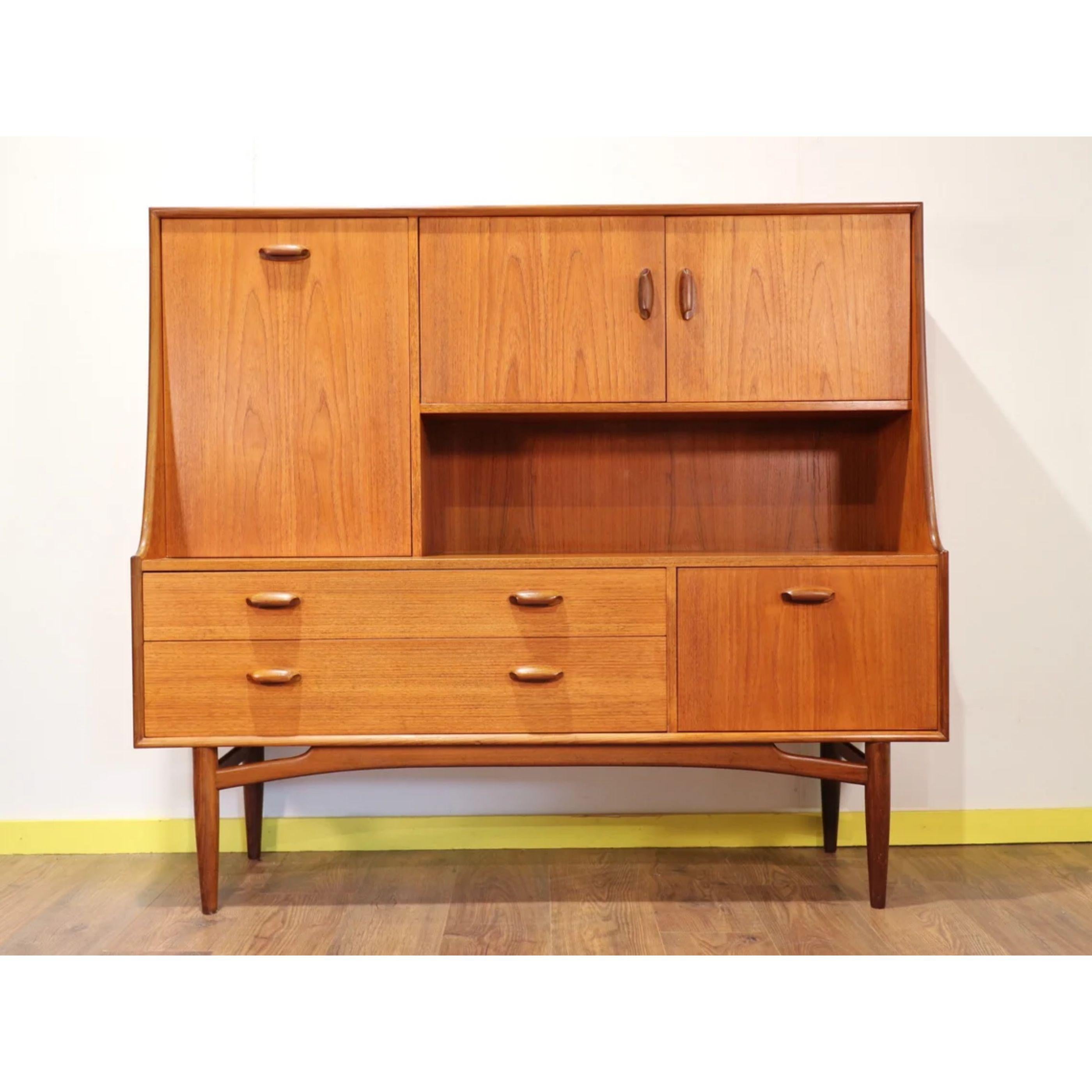A wonderful Mid-century vintage teak G Plan sideboard highboard with cocktail cabinet, drawers and 2 spacious cupboards. Set on an elegant but sturdy solid teak leg frame which illustrates the quality of the design and craftsmanship of the piece.