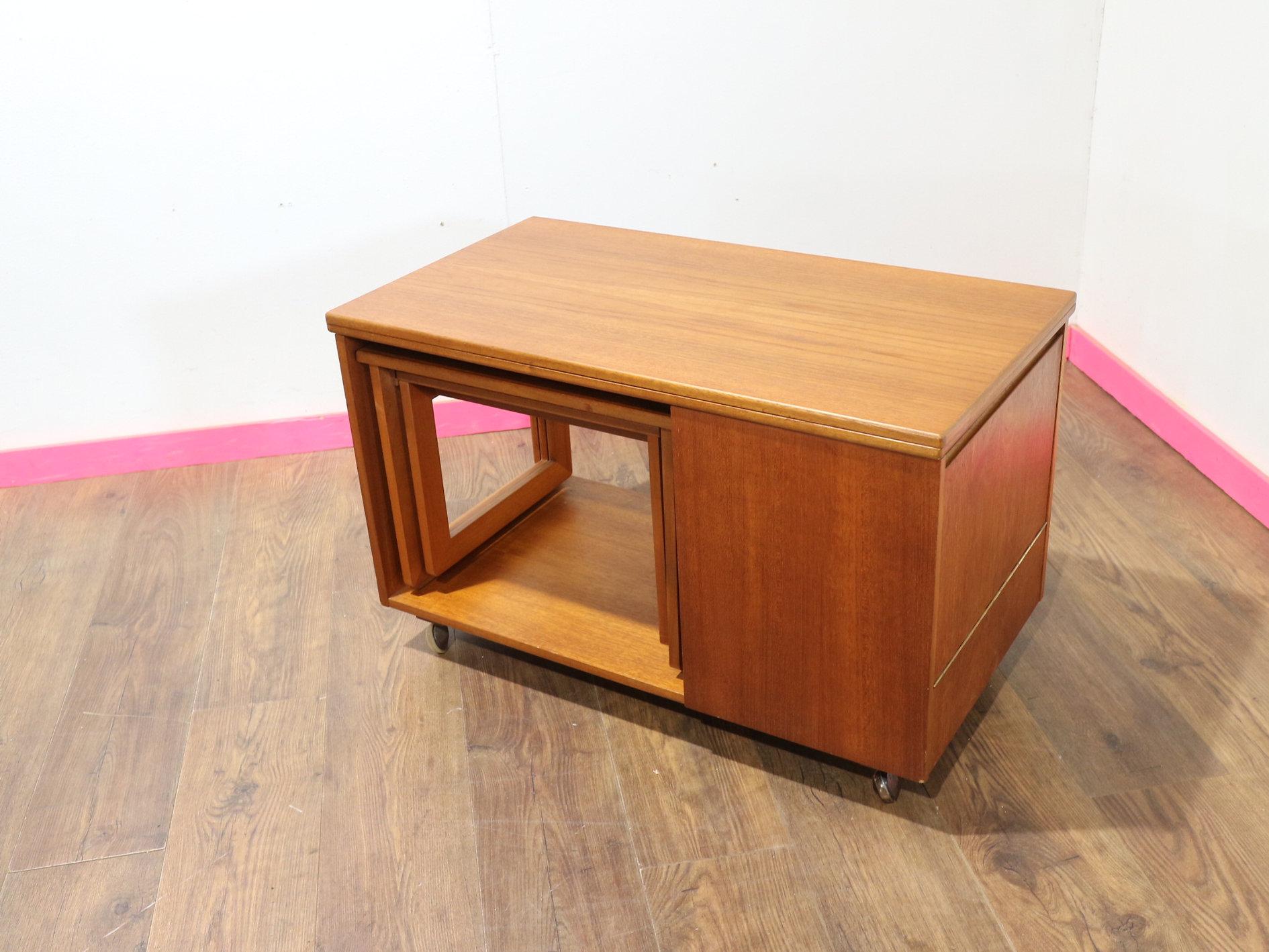 Discover the timeless elegance with this Mid Century Modern Vintage Teak Side End Nesting Table by McIntosh, exuding the Danish style A.H Mcintosh of Scotland is renowned for. This versatile piece features pull-out nesting tables and an extending