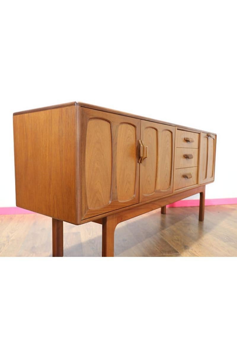 Introduce timeless elegance to your living space with this scarcely seen Mid Century teak credenza manufactured by G-Plan. A beautifully proportioned piece constructed from teak with gorgeous sculpted handles, it offers not only visual appeal but