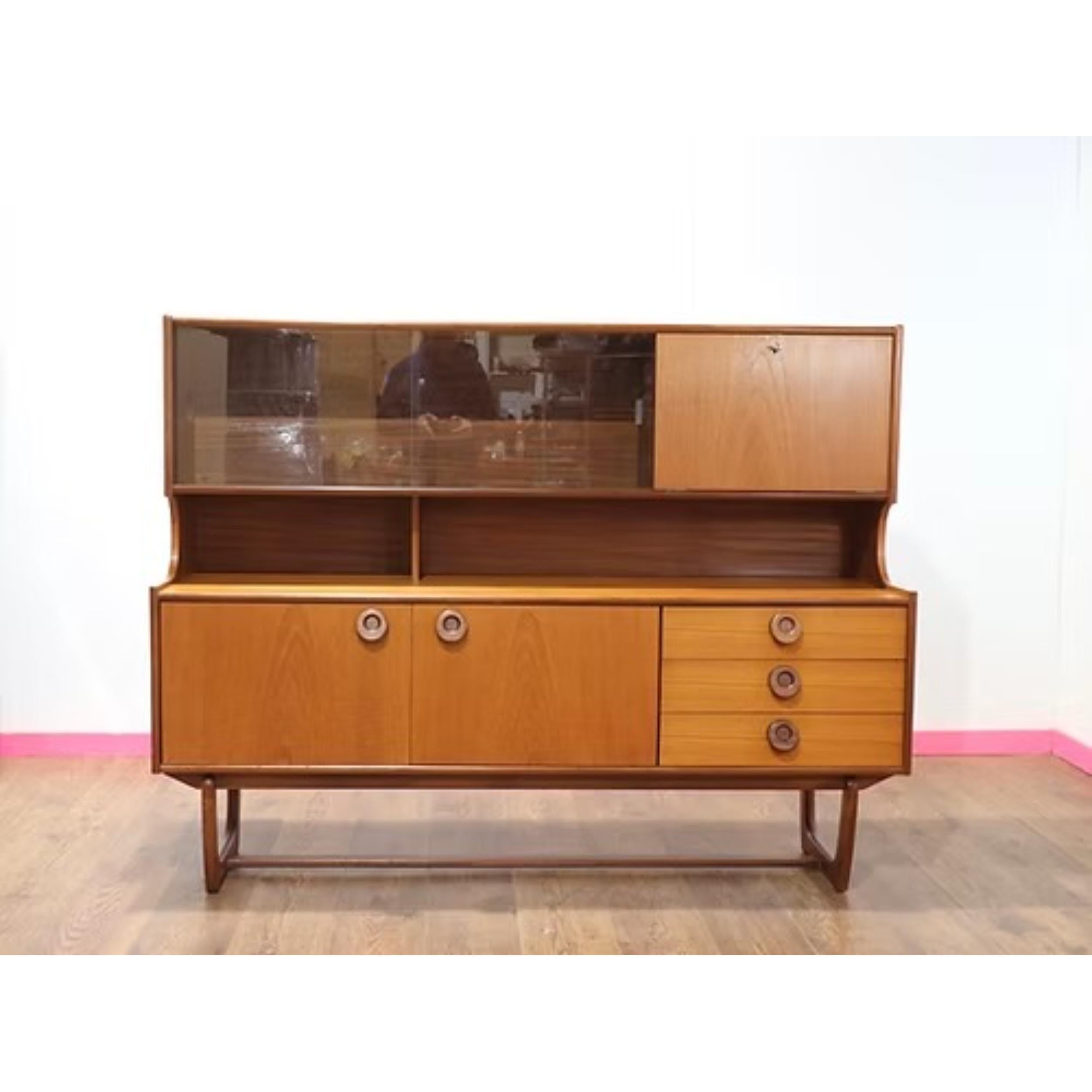 Nous vous présentons cette crédence haute Vintage Mid Century Modern de Portwood, une pièce étonnante du célèbre fabricant de meubles britannique. Cette crédence haute est le mélange parfait du design moderne du milieu du siècle et du flair vintage,