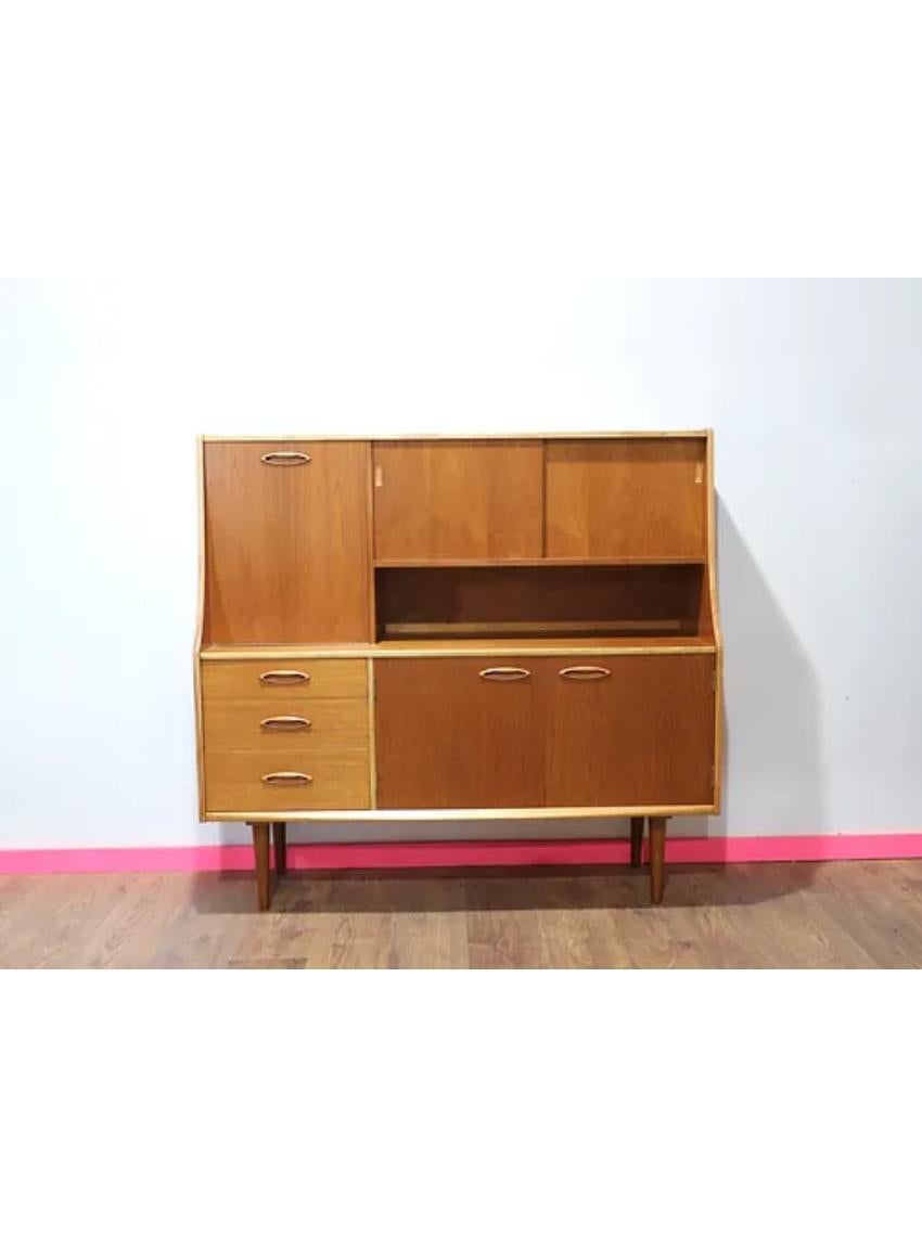 A Jentique Mid-Century Teak Sideboard Highboard, Danish styled, British made.

The compact design is great for the modern home and offers lots of storage.

Provides great style, storage and display options for a kitchen or living area.

A large
