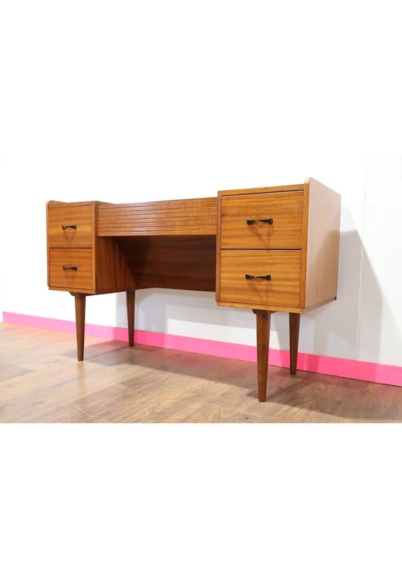 A beautiful desk / vanity made by British furniture maker Austinsuite. A great example of a mid century vanity with some super storage under the central tambour door 