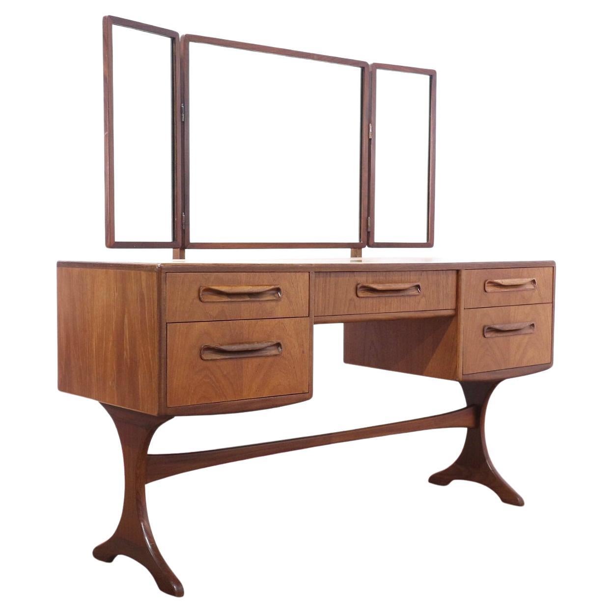 Enhance your living space with this stunning vanity desk by British furniture maker G Plan. With its fabulous legs and stunning style, it’s a true embodiment of mid-century modern design. Versatile and chic, this piece features removable mirrors,