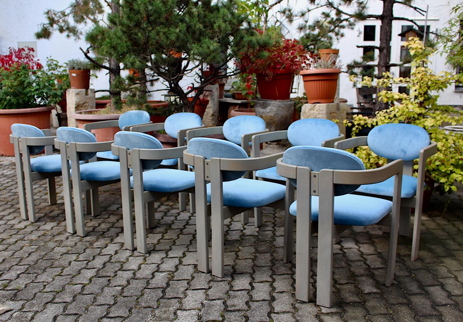 Mid-Century Modern vintage set of ten vintage dining chairs or armchairs from grey stained beech and
blue velvet upholstery Italy 1970s.
The grey stained and lacquered beechwood frame shows an upholstery with newly covered sky blue toned velvet