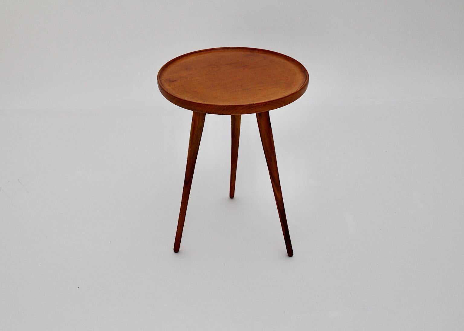 Mid-Century Modern vintage tiny side table or flower stand from walnut and solid beech in smoothly brown color 1950s Austria.
A charming side table or flower stand with three (3) feet and a circular plate with a bent upwards trim.
This amazing