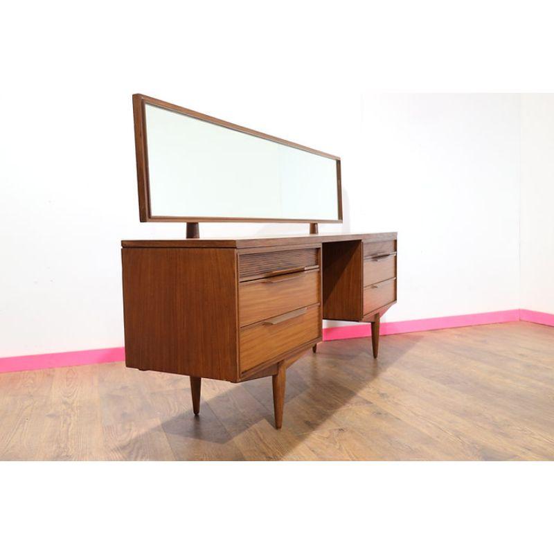 This beautiful Vanity was manufactured by British company White & Newton in the 1960s. A stunning piece of furniture made of mahogany and rosewood. On both sides of the vanity table there are cabinets with three drawers (the upper drawers are