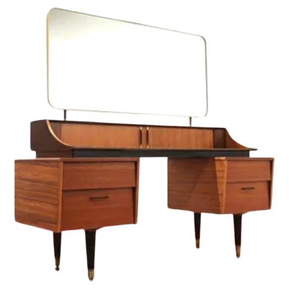 Introducing the Mid Century Modern Vintage Vanity Desk With Mirror by Wrighton, a stunning piece made by the esteemed British furniture maker. Crafted from a beautiful combination of teak and afromosia, this vanity exudes timeless elegance and