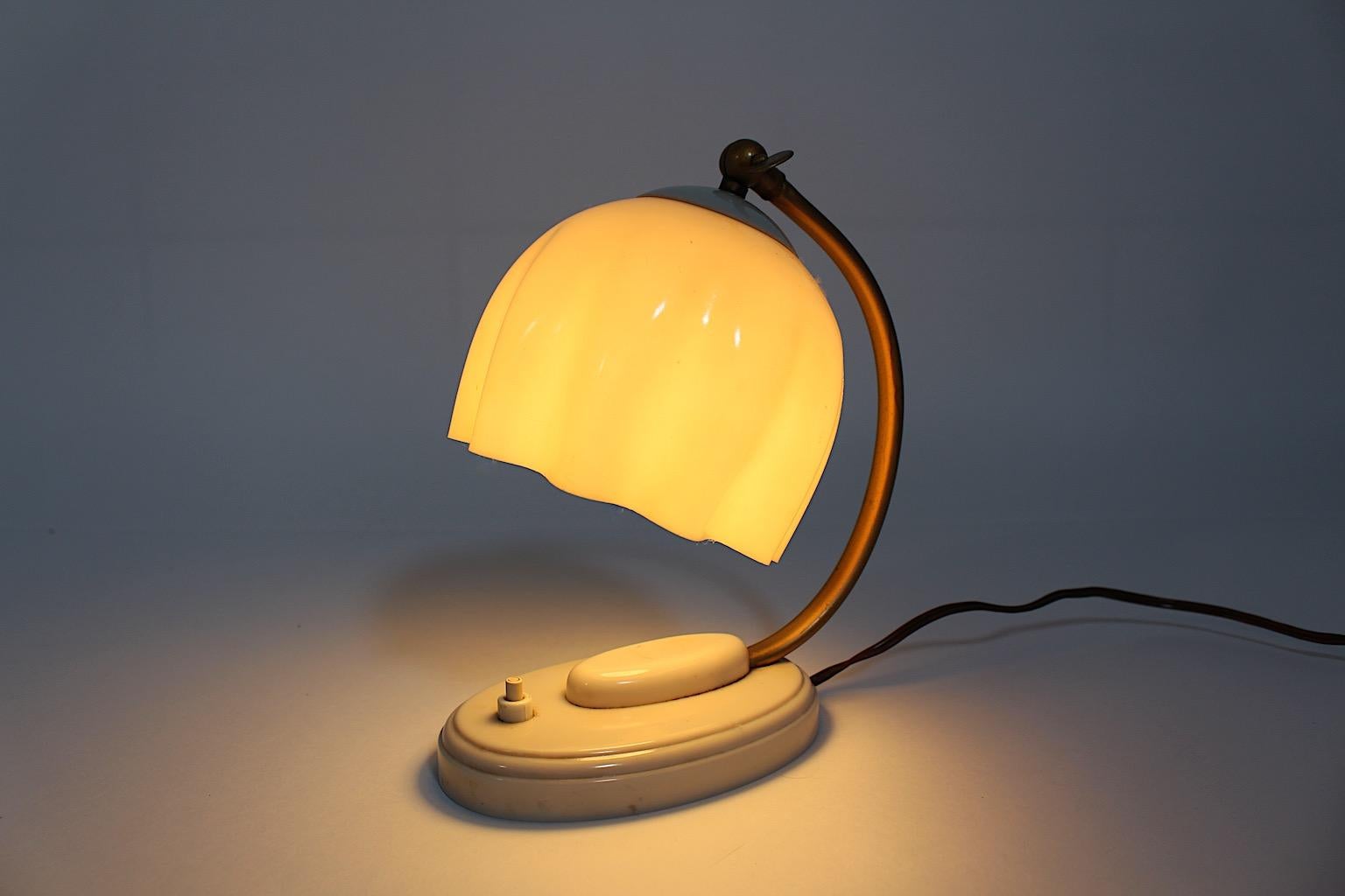 Mid Century Modern Vintage White Fazzoletto table lamp or bedside lamp from bakelite and golden metal 1950s Germany.
A stunning vintage table lamp or bedside lamp from bakelite in white cream color with a golden lacquered and slightly curved metal