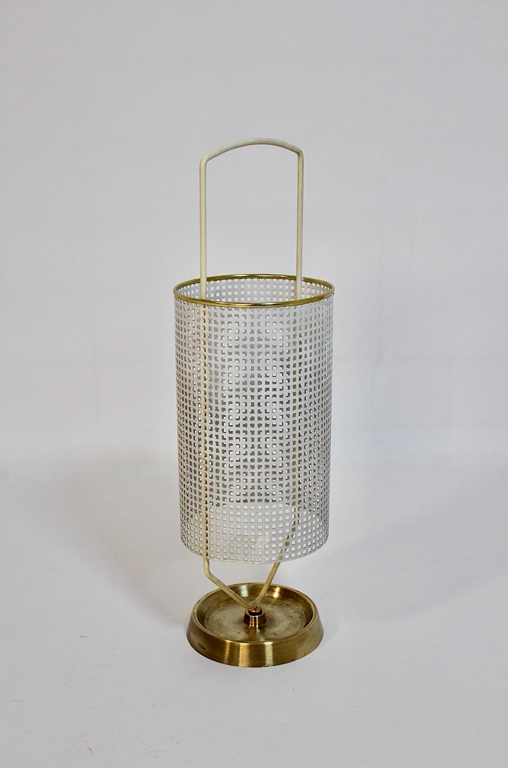 Mid-Century Modern vintage umbrella stand from white metal and brass details 1960s Germany.
An elegant umbrella stand from white perforated sheet metal and brass details 1960s Germany.
This umbrella stand shows a perforated white sheet metal body
